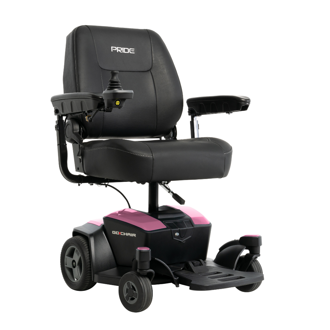 The Pride Mobility Go Chair® Portable Powerchair is a black and pink electric wheelchair with four wheels, cushioned seat and backrest, armrests, right-side joystick control, visible Pride branding, and feather-touch disassembly for easy transport.